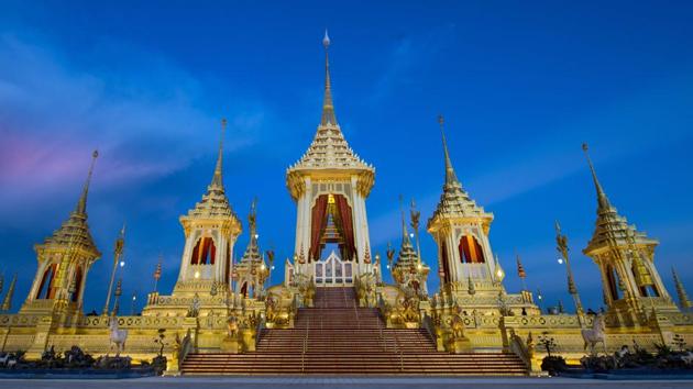 The royal pavilion where King Bhumibol Adulyadej will be cremated on October 26 is framed by the blue sky at dusk. The kingdom has been prepping for the event since he died at the age of 88 on October 13, 2016, triggering an outpouring of grief. The elaborate golden crematorium is a symbolic representation of Mount Meru — the mythical mountain where Hindus believe the gods live and where the king will ascend to after his cremation. (Roberto Schmidt / AFP)