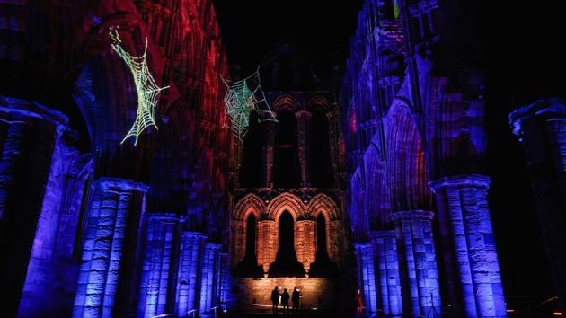 On the occasion of Halloween, the story of Dracula is brought back to life before public within the Abbey ruins all aglow, with a twist in their usual show. (Ian Forsyth / Getty Images) 
