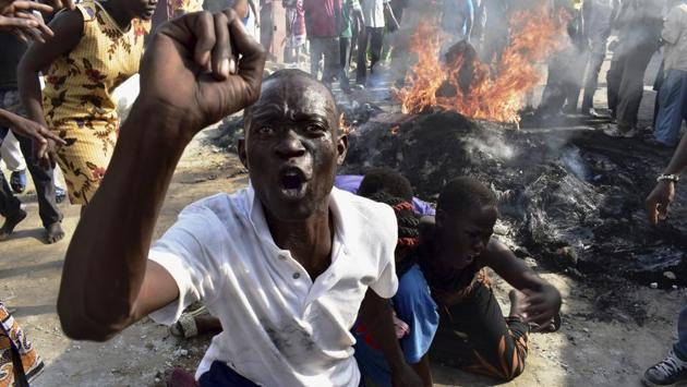 An opposition supporter reacts after burning tyres during demonstrations in Mombasa, Kenya on Thursday, October 26, 2017. (AP)