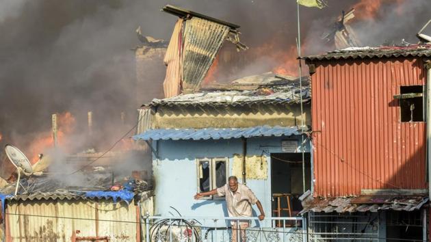 A fire broke out in a slum near Bandra (East) station on Thursday as gas cylinders exploded during a demolition drive by the Brihanmumbai Municipal Corporation (BMC). (Kunal Patil / HT Photo)