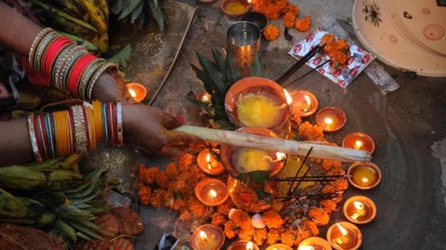 A woman offer prayers on the occasion of Chhath Puja in Lucknow. Vegetables, fruits and other natural products are offered to the Sun God on the last two days, and ‘thekua’ — a delicacy made out of fine flour, ghee and sugar is the main ‘prasad’, which is then distributed after the offerings. (Subhankar Chakraborty/HT PHOTO)