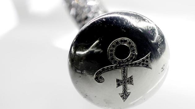 Crystals sit in an engraved walking cane with the famous ‘love symbol’ used by Prince, on display at the exhibition. In 1993, following a lawsuit with Warner Bros., Prince had changed his name to an unpronounceable symbol to emancipate himself from his contract. (Peter Nicholls / REUTERS)