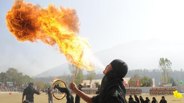 A new recruit of Jammu and Kashmir Police blows fire with his mouth during a passing-out parade at Manigam on October 25, 2017 in Ganderbal, Jammu and Kashmir. A total of 696 recruits were formally inducted into the Jammu and Kashmir Police after completing training in physical fitness, weapon handling, counter insurgency and dealing with the law and order situation. (Waseem Andrabi / HT Photo)