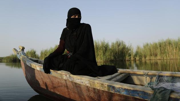 A fisherwoman prepares to spread her netting beside a bank of reeds in the marsh of Chabaish, Iraq. After the 2003 US-led invasion toppled Saddam, residents dismantled the local dams, allowing the waters to return, and with them the plants and animals on which the community relied. But still, today’s marshlands are only around 14 percent of what they were in the 1970s. Most of the Iraqis who lived in that era speak of a paradise lost. (Susannah George / AP)