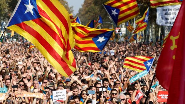 People react as they watch on giant screens a plenary session outside the Catalan regional parliament in Barcelona, Spain. (REUTERS) People react as they watch on giant screens a plenary session outside the Catalan regional parliament in Barcelona, Spain. (REUTERS)