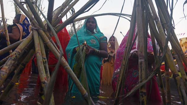 Women stand in the river to offer prayers as part of Chhat Puja celebrations. (Pratham Gokhale/HT Photo)
