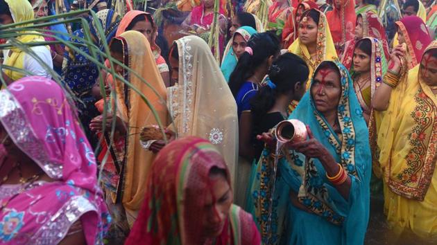 Women offer prayers to the Sun God at Karvenagar in Pune as part of the Chhat Puja celebrations. (Pratham Gokhale/HT Photo)