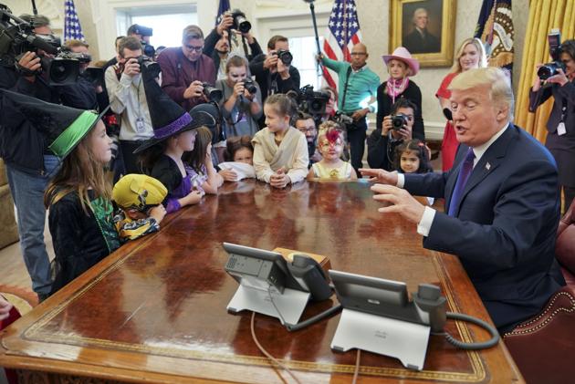 Trump also joked with the kids about their parents’ professions. ‘You going to grow up to be like your parents?’ he asked. ‘Don’t answer. That can only get me in trouble, that question,’ he joked. (AP Photo)