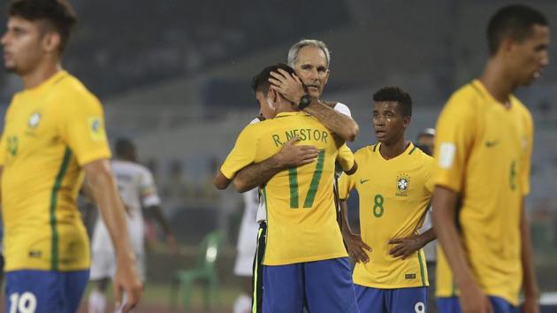 Brazil coach Carlos Amadeu hugs forward Rodrigo Nestor after the team’s victory. (AP)