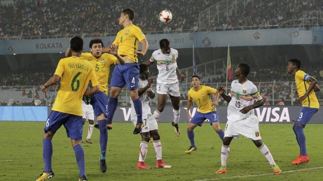Brazil's Lucas Halter and Mali's Mamadi Fofana, in white, jump for the ball. (AP)