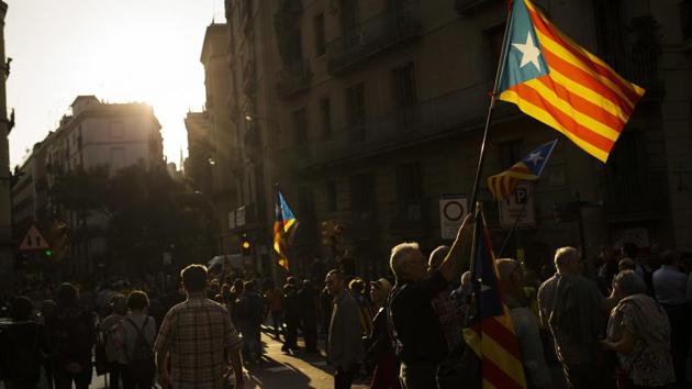 People wave "esteladas", Catalonian independence flags, in Barcelona.(AP Photo) People wave "esteladas", Catalonian independence flags, in Barcelona.(AP Photo)