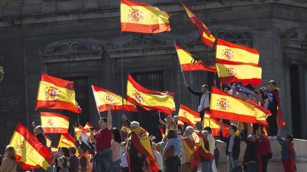People wave Spanish flags during a mass protest over Catalonia’s declaration of independence in Madrid on Saturday. (AP Photo) People wave Spanish flags during a mass protest over Catalonia’s declaration of independence in Madrid on Saturday. (AP Photo)