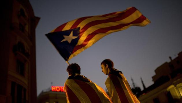 Pro-independence supporters carry an 'Estelada' or independence flag in downtown Barcelona Friday, Oct. 27, 2017. (AP) Pro-independence supporters carry an 'Estelada' or independence flag in downtown Barcelona Friday, Oct. 27, 2017. (AP)