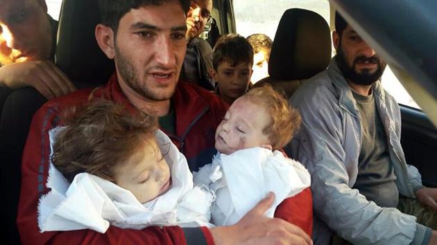 In this April 4, 2017 file photo, Abdel Hameed Alyousef, 29, holds his twin babies who were killed during a suspected chemical weapons attack, in Khan Sheikhoun in the northern province of Idlib, Syria.(AP File Photo) In this April 4, 2017 file photo, Abdel Hameed Alyousef, 29, holds his twin babies who were killed during a suspected chemical weapons attack, in Khan Sheikhoun in the northern province of Idlib, Syria.(AP File Photo)
