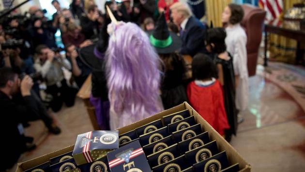 US President Donald Trump meets with children of members of the press for Halloween in the Oval Office of the White House in Washington, DC. (AFP Photo)