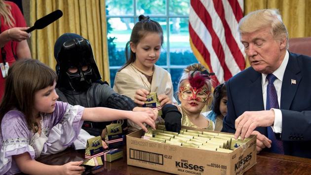 US President Donald Trump meets with children of members of the press for Halloween in the Oval Office of the White House in Washington, DC, on October 27, 2017.(AFP) US President Donald Trump meets with children of members of the press for Halloween in the Oval Office of the White House in Washington, DC, on October 27, 2017.(AFP)