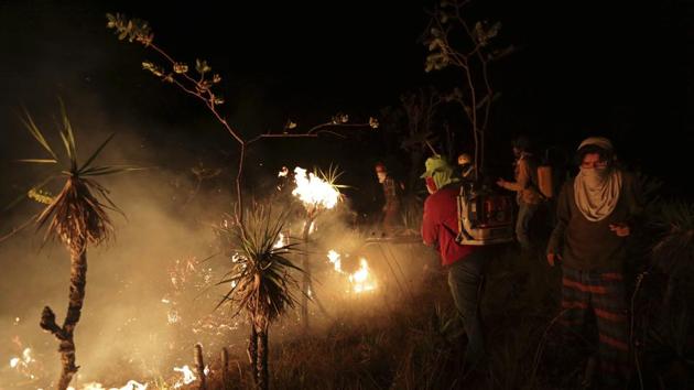 Locals work to contain a wild fire in the Chapada dos Veadeiros National Park in Goias state, Brazil, on Saturday. (AP) Locals work to contain a wild fire in the Chapada dos Veadeiros National Park in Goias state, Brazil, on Saturday. (AP)