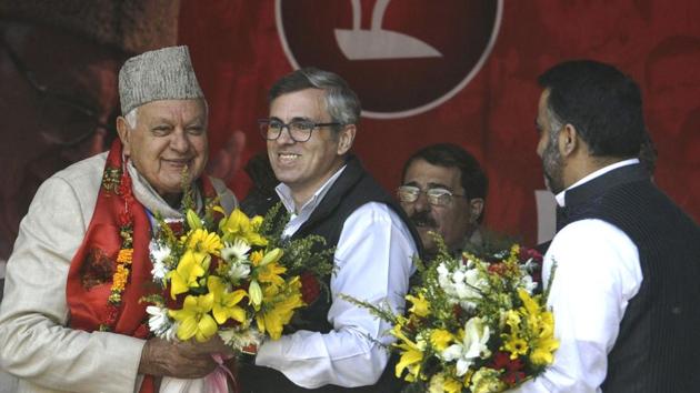 National Conference working president Omar Abdullah greets his father Farooq Abdullah at the party’s state delegates' session in Srinagar on Sunday.(Waseem Andrabi /HT Photo)