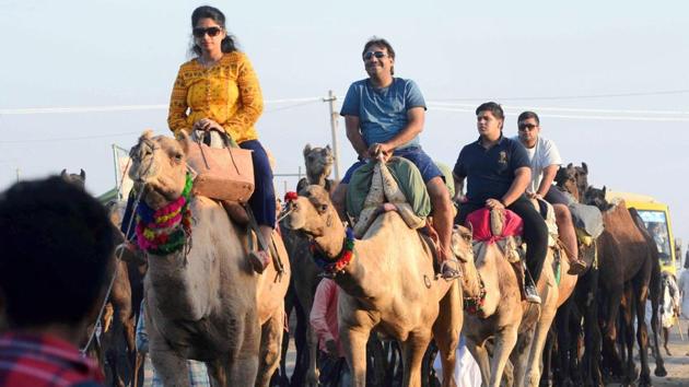 Tourists enjoy a camel ride during the International Camel Fair in Rajasthan. The peak celebrations generally occur in the last five days with the festival ending on Kartik Poornima, the full moon day of Kartik in Hindu calendar. (PTI)