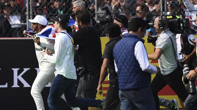 Hamilton celebrated in style as he joined an elite list of Formula One drivers with his result. (AP)