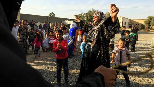 The dancers hopped and swayed to-and-fro as children ran around. Elders looked on approvingly from seats and benches on the edge of the makeshift dance floor. (Delil souleiman / AFP) 