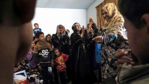 Syrian women and children danced as they participated in celebrations. Female guests, forced under jihadist rule to wear all-enveloping black robes including gloves and face veils, took obvious delight in sporting patterned robes and bright red lipstick. Some covered their hair with matching patterned scarves, while others, including the bride, had their locks coiffed for the occasion. (Delil souleiman / AFP) 