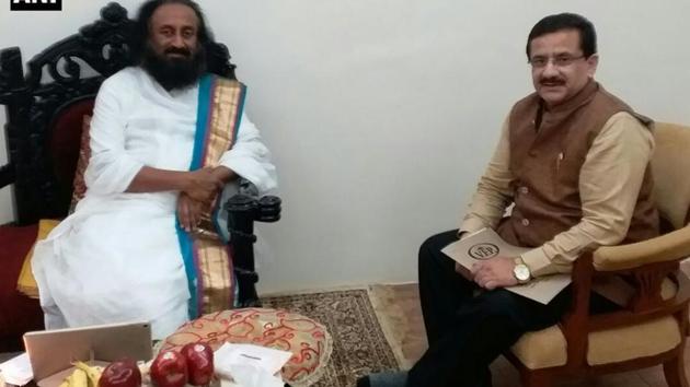 UP Shia Central Waqf Board chief Waseem Rizvi with Art of Living founder Sri Sri Ravishankar on Tuesday.(ANI Twitter)