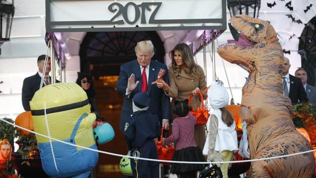 President Donald Trump and first lady Melania Trump hand out treats on Halloween at the White House on Monday. (AP) President Donald Trump and first lady Melania Trump hand out treats on Halloween at the White House on Monday. (AP)