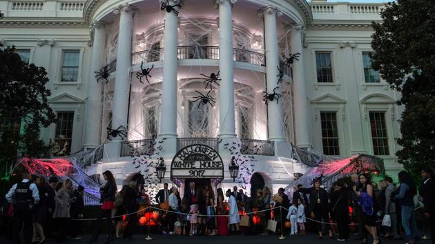 US President Donald Trump and First Lady Melania Trump hand out candy to children during a Halloween event at the decked out White House in Washington. Kids from over 20 schools in the District of Columbia, Maryland and Virginia attended the celebrations on the South Lawn along with military families and members of community organisations. (Nicholas Kamn / AFP)
