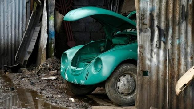 A VW Beetle is seen inside a painting room at a garage in Addis Ababa. ‘They are lovely cars,’ said Teferi Markos, a mechanic in Kinfe’s garage. ‘You get satisfied when you fix them. If you want to change the colour, they absorb any paint.’ (Tiksa Negeri / REUTERS) A VW Beetle is seen inside a painting room at a garage in Addis Ababa. ‘They are lovely cars,’ said Teferi Markos, a mechanic in Kinfe’s garage. ‘You get satisfied when you fix them. If you want to change the colour, they absorb any paint.’ (Tiksa Negeri / REUTERS)