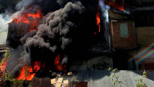 Smoke rises from a building where a major fire broke out, at Tokobari Satra in Guwahati on Wednesday. (PTI) Smoke rises from a building where a major fire broke out, at Tokobari Satra in Guwahati on Wednesday. (PTI)
