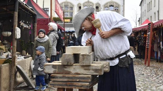 A wood cutter engraves wood in the main square in Wittenberg on the 500th anniversary of the Reformation. The Vatican and Lutheran World Federation in their joint statement committed to ‘overcome remaining differences between us’, adding that it was ‘clear that what we have in common is far more than that which still divides us’. (John Macdougall / AFP) 
