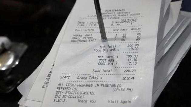 A bill is clumped together with others at a restaurant with GST added to it, in Mumbai. (AP Photo) A bill is clumped together with others at a restaurant with GST added to it, in Mumbai. (AP Photo)