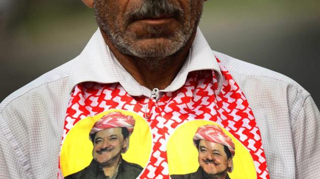 An Iraqi Kurd wears a scarf bearing a portrait of the Iraqi Kurdish leader Massud Barzani, during a protest in his support, in Erbil. The loss of the oilfields, which provided income that would have been critical to an independent Kurdish state, sparked recriminations among Kurds and ratcheted up the pressure on Barzani to quit. (Safin Hamed / AFP) An Iraqi Kurd wears a scarf bearing a portrait of the Iraqi Kurdish leader Massud Barzani, during a protest in his support, in Erbil. The loss of the oilfields, which provided income that would have been critical to an independent Kurdish state, sparked recriminations among Kurds and ratcheted up the pressure on Barzani to quit. (Safin Hamed / AFP)