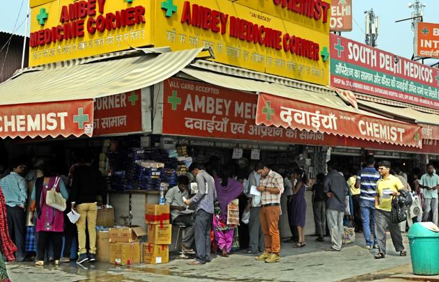 People outside a chemist shop in New Delhi.(Sonu Mehta/ HT Photo)