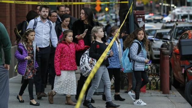 Children are evacuated from a school as emergency personal respond after the truck ramming attack in Lower Manhattan on October 31, 2017. The attack unfolded as nearby schools were letting out on a Halloween afternoon. President Donald Trump responded to the attack on Twitter: ‘In NYC, looks like another attack by a very sick and deranged person. Law enforcement is following this closely. NOT IN THE U.S.A.!’ (Kena Betancur / Getty Images / AFP) Children are evacuated from a school as emergency personal respond after the truck ramming attack in Lower Manhattan on October 31, 2017. The attack unfolded as nearby schools were letting out on a Halloween afternoon. President Donald Trump responded to the attack on Twitter: ‘In NYC, looks like another attack by a very sick and deranged person. Law enforcement is following this closely. NOT IN THE U.S.A.!’ (Kena Betancur / Getty Images / AFP)