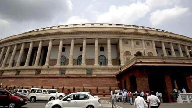 Traffic flows in front of Parliament House before the start of monsoon session in New Delhi. Traffic flows in front of Parliament House before the start of monsoon session in New Delhi.