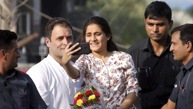 A young girl takes selfie with Congress vice president Rahul Gandhi during his road show in Bharuch on Wednesday.(PTI Photo)