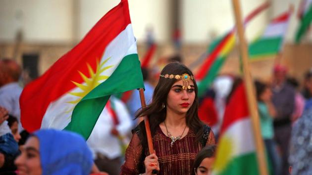 Syrian Kurds wave the Kurdish flag in celebration of the independence referendum in Iraq’s autonomous northern Kurdish region, in the Syrian city of Qamishli on September 26, 2017. Thousands in the Kurdish region had cast votes on September 25 in a referendum which was billed as a first step towards independence from Baghdad, defying fears that the outcome could spark violence. (Delil Souleiman / AFP ) Syrian Kurds wave the Kurdish flag in celebration of the independence referendum in Iraq’s autonomous northern Kurdish region, in the Syrian city of Qamishli on September 26, 2017. Thousands in the Kurdish region had cast votes on September 25 in a referendum which was billed as a first step towards independence from Baghdad, defying fears that the outcome could spark violence. (Delil Souleiman / AFP )