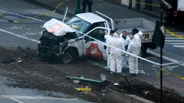 Investigators inspect the truck which plowed into a pedestrian and bike path in Lower Manhattan. The driver was shot in the abdomen by police after jumping out of the truck with what turned out to be paintball and pellet guns and shouting what witnesses said was ‘Allahu Akbar’ authorities said. The man underwent surgery and was in critical condition but was expected to survive. (Don Emmert / AFP) Investigators inspect the truck which plowed into a pedestrian and bike path in Lower Manhattan. The driver was shot in the abdomen by police after jumping out of the truck with what turned out to be paintball and pellet guns and shouting what witnesses said was ‘Allahu Akbar’ authorities said. The man underwent surgery and was in critical condition but was expected to survive. (Don Emmert / AFP)