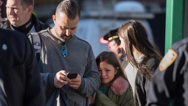 A young girl reacts as police officers block an area following the shooting incident in New York. Tuesday’s attack was the first deadly terror-related incident in the US financial and entertainment capital since the Al-Qaeda hijackings brought down the Twin Towers, killing more than 2,700 people on 9/11. (Don Emmert / AFP) A young girl reacts as police officers block an area following the shooting incident in New York. Tuesday’s attack was the first deadly terror-related incident in the US financial and entertainment capital since the Al-Qaeda hijackings brought down the Twin Towers, killing more than 2,700 people on 9/11. (Don Emmert / AFP)