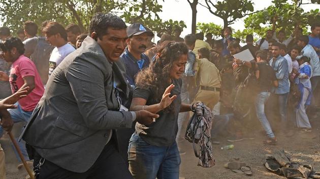 A local helps a woman who fell down during the police lathi charge. (Satyabrata Tripathy/HT Photo)