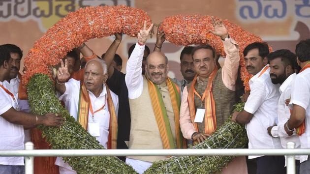 BJP national president Amit Shah(C), BJP Karnataka president and Chief Minister candidate Yeddurappa(L) and Union Minister Ananth Kumar during Nava Karnataka Nirmana Parivarthana Yatra in Bengaluru. (Arijit Sen / HT Photo) BJP national president Amit Shah(C), BJP Karnataka president and Chief Minister candidate Yeddurappa(L) and Union Minister Ananth Kumar during Nava Karnataka Nirmana Parivarthana Yatra in Bengaluru. (Arijit Sen / HT Photo)