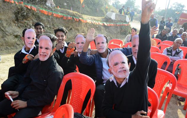 Youngsters wearing masks of Prime Minister Narendra Modi during the election rally of BJP candidate Pramode Sharma at Shoghi in Shimla. (Deepak Sansta /ht)