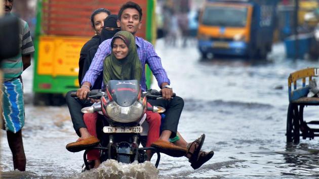 A motorcyclist wades through a flooded street in an inundated locality in Chennai. Traffic on most of the arterial roads came to a crawling halt as the roads were flooded with water of up to knee level in most areas. (PTI) A motorcyclist wades through a flooded street in an inundated locality in Chennai. Traffic on most of the arterial roads came to a crawling halt as the roads were flooded with water of up to knee level in most areas. (PTI)