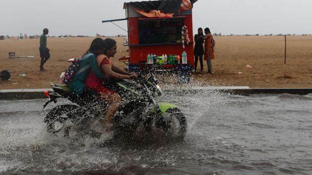 Women ride a bike during monsoon rains at Marina beach in Chennai. Two girls playing outside their homes died on Wednesday due to electrocution in Kodungaiyur in Chennai as heavy rains pounded the city and suburban areas. (Arun Sarkar / AFP) Women ride a bike during monsoon rains at Marina beach in Chennai. Two girls playing outside their homes died on Wednesday due to electrocution in Kodungaiyur in Chennai as heavy rains pounded the city and suburban areas. (Arun Sarkar / AFP)