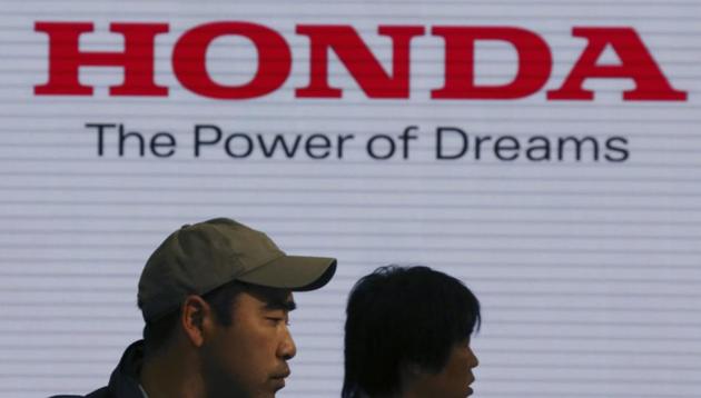 Visitors walk through a showroom of the Honda Motor Co.(AP File Photo)