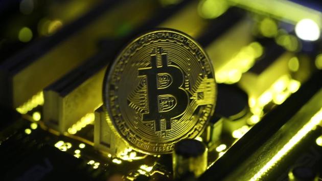 A copy of bitcoin standing on PC motherboard is seen in this illustration, October 26, 2017.(REUTERS)