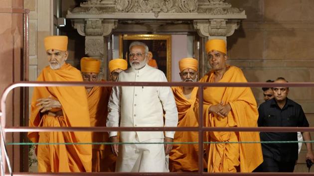 Prime Minister Narendra Modi walks accompanied by head saint of The Bochasanwasi Akshar Purushottam Swaminarayan Sanstha (BAPS) Mahant Swami Maharaj, left, during the silver jubilee celebration of Akshardham temple in Gandhinagar on Nov 2. (AP Photo) Prime Minister Narendra Modi walks accompanied by head saint of The Bochasanwasi Akshar Purushottam Swaminarayan Sanstha (BAPS) Mahant Swami Maharaj, left, during the silver jubilee celebration of Akshardham temple in Gandhinagar on Nov 2. (AP Photo)