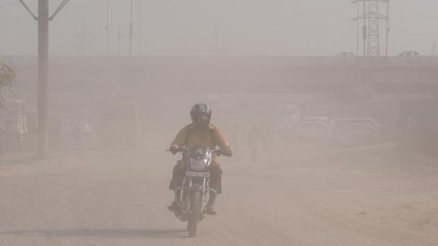 A motorist rides through a dust filled landscape in Gazipur, New Delhi. A Graded Response Action Plan to combat air pollution came into force for the first time last month, which involved taking measures such as bans on garbage burning and firecrackers, closing brick kilns and mechanised sweeping of roads as air quality turned from ‘moderate’ to ‘poor’ (Ravi Choudhary/HT PHOTO) A motorist rides through a dust filled landscape in Gazipur, New Delhi. A Graded Response Action Plan to combat air pollution came into force for the first time last month, which involved taking measures such as bans on garbage burning and firecrackers, closing brick kilns and mechanised sweeping of roads as air quality turned from ‘moderate’ to ‘poor’ (Ravi Choudhary/HT PHOTO)